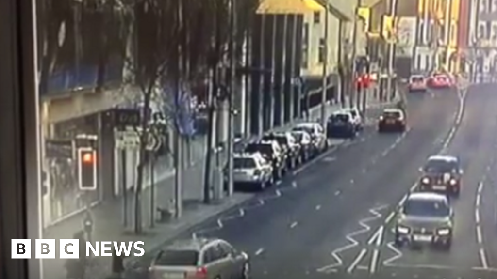 Driver narrowly misses mother and children after driving through red