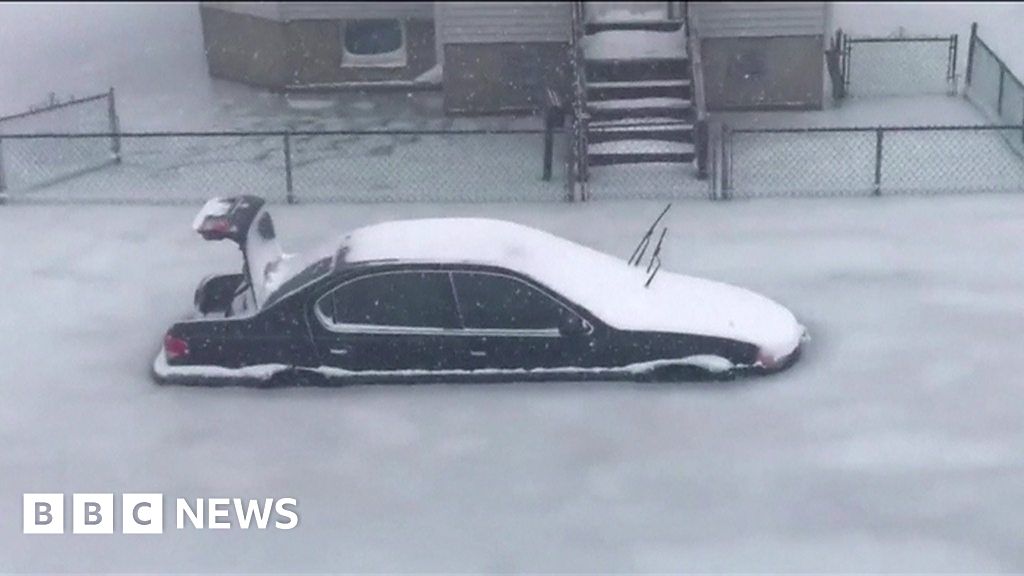 Cars frozen in Revere, Massachusetts' floodwaters - BBC News