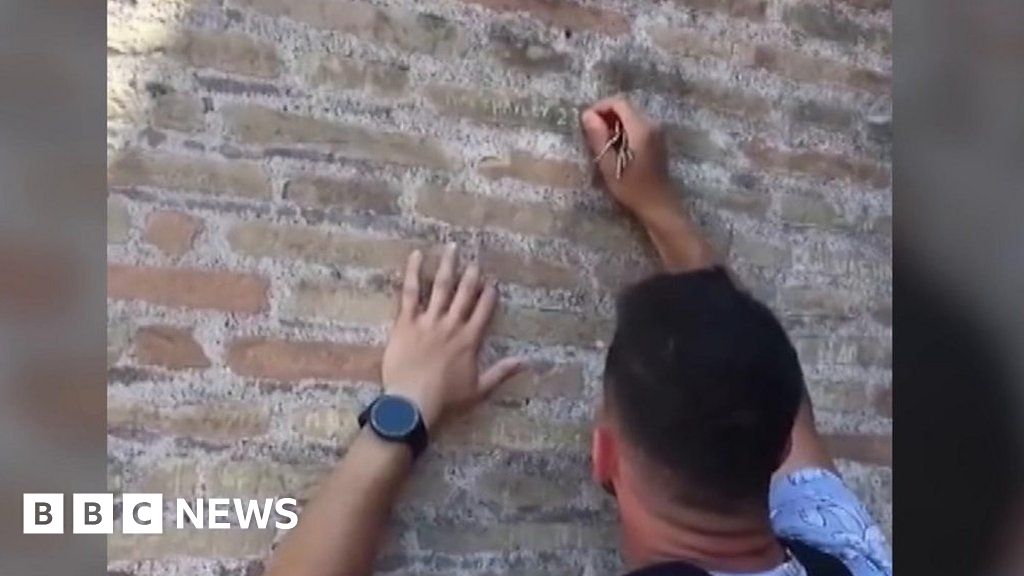 Police hunt man filmed carving names on Colosseum