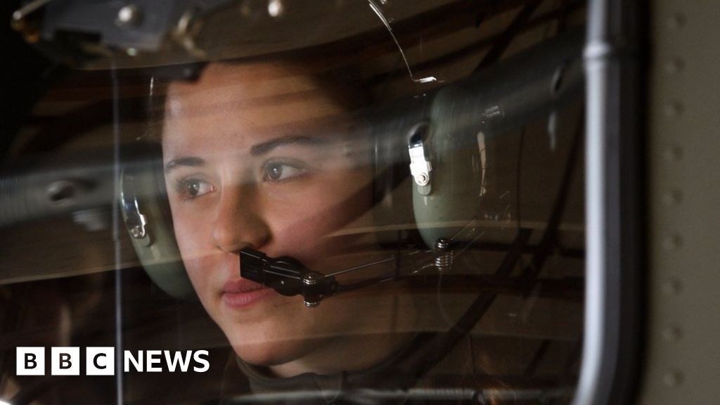 A female soldier in a helicopter at the Swiss Air Force Base of Payerne.