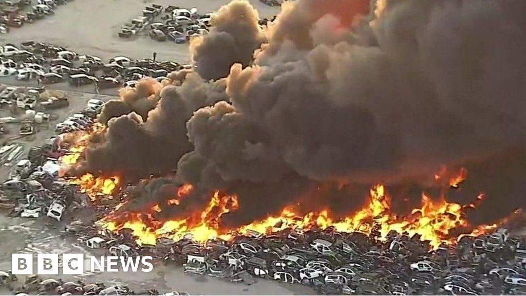 Scores of cars on fire in junkyard blaze