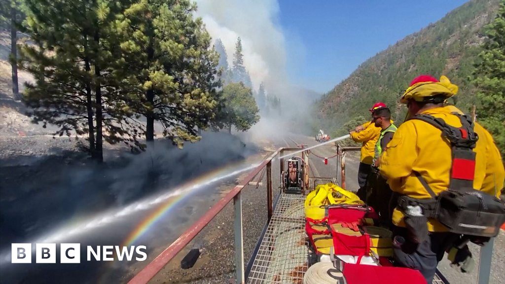 Wildfires: Firefighters battle blaze from top of moving train