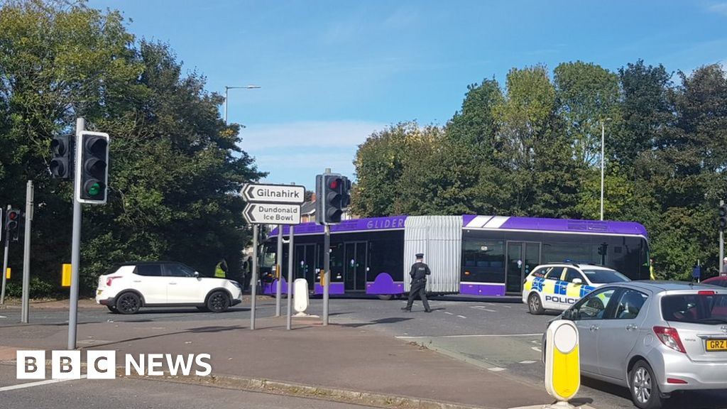 Glider bus gets stuck turning a corner BBC News