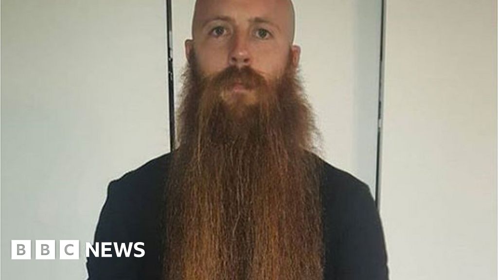 Waist-length beard shaved off for charity - BBC News