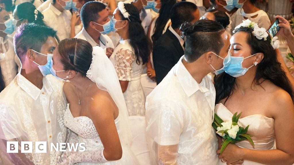 Newly Weds Kiss Behind Masks In Manila