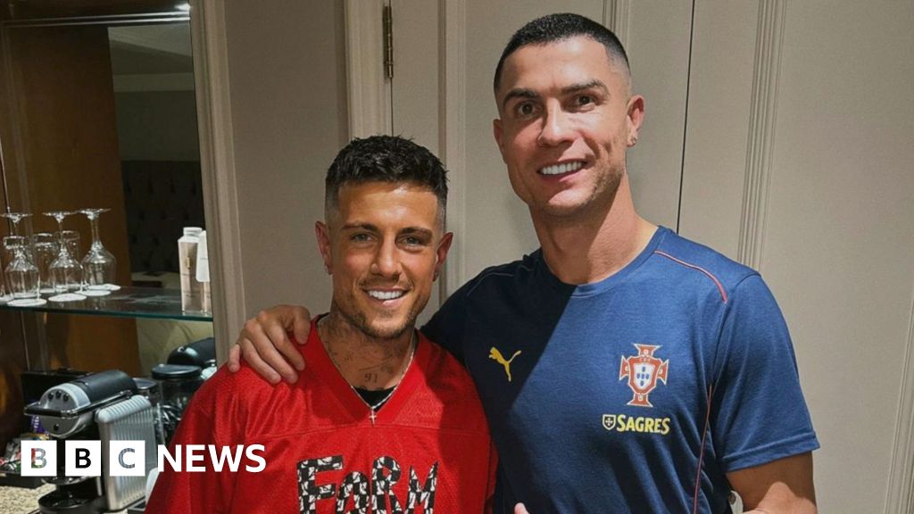 Barber preparing to cut a footballer's hair in a professional setting