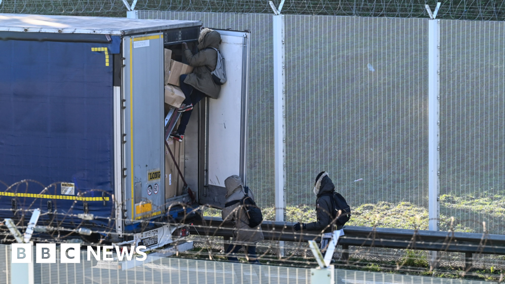 Migrants breaking into lorry near Calais