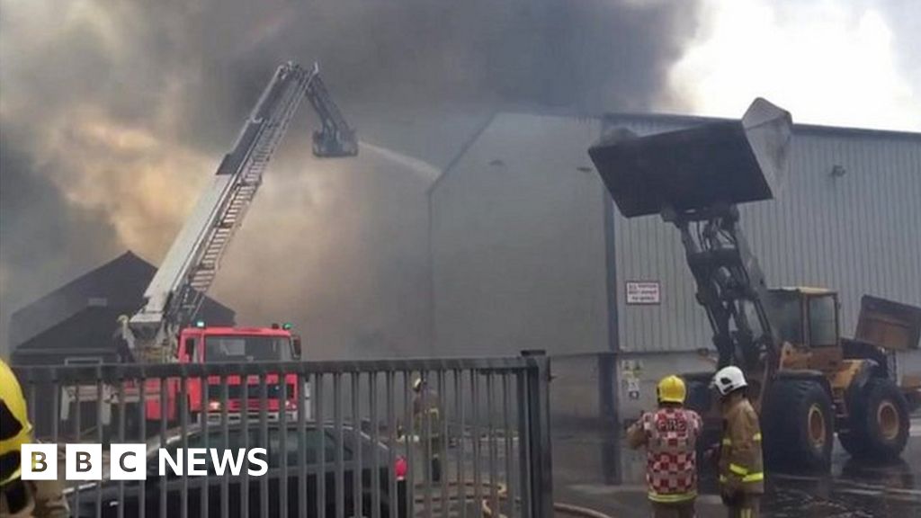 Crews tackle large sawdust mill fire in Lancashire - BBC News