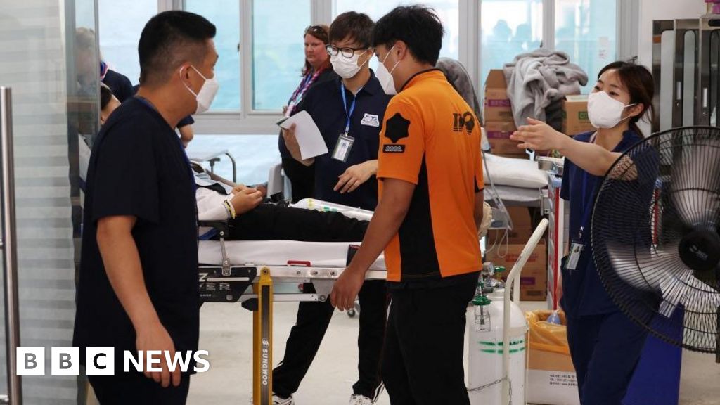 Medics treating a person on a stretcher