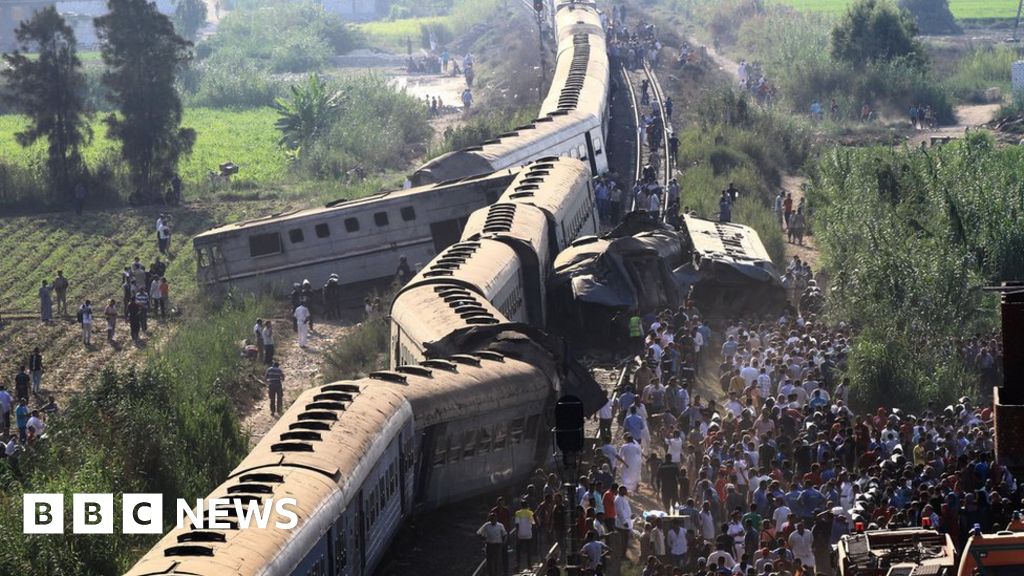 A general view of people by the wreckage after two passenger trains collided in Alexandria