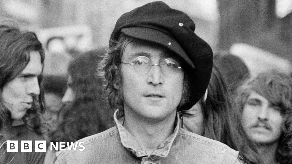Woman mourns the death of former Beatles member, guitarist John