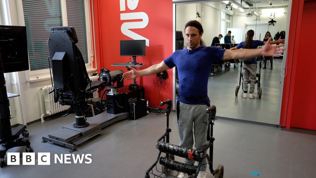 Paralysed man with severed spine walks thanks to implant – BBC News