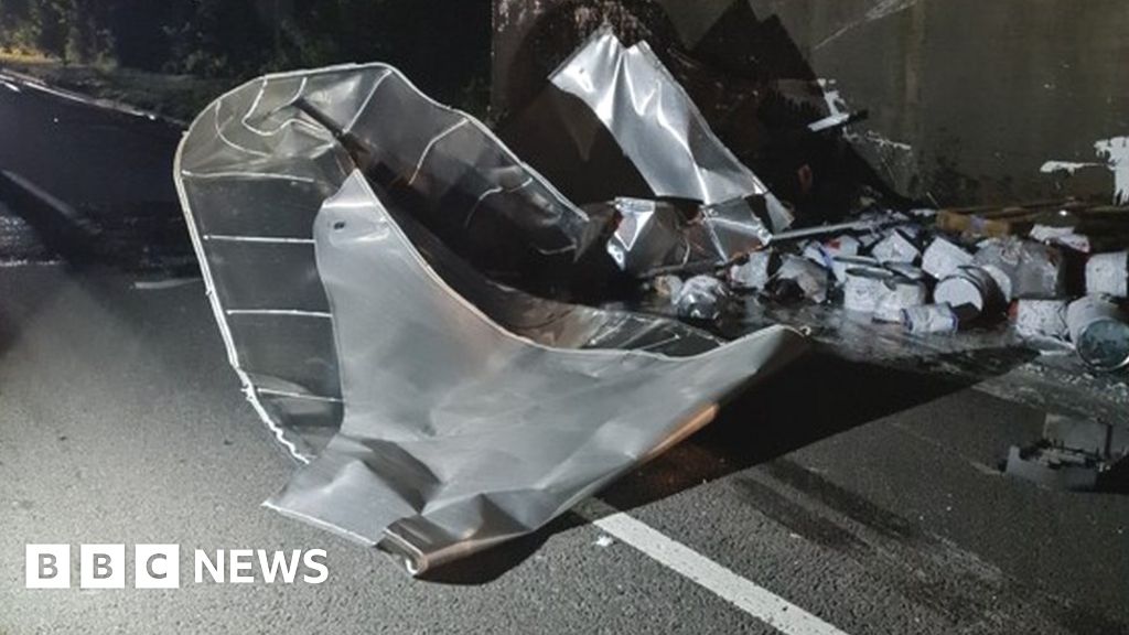 Lorry strikes railway bridge and sheds paint over road