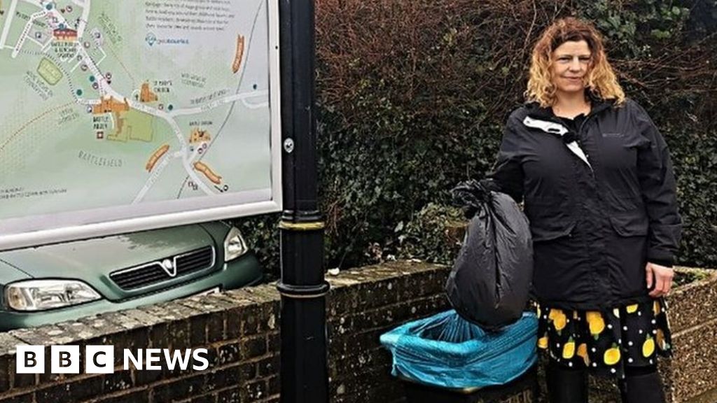 Olivia Post holds a bag over a council bin