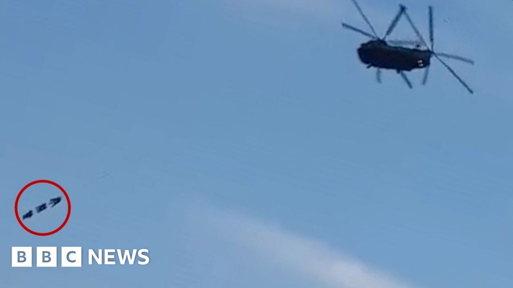 Special forces dangle from Chinook helicopter over town