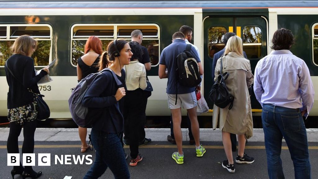 People waiting to get on to a train