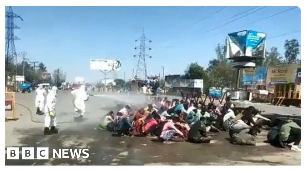 Coronavirus: Anger as migrants sprayed with disinfectant in India