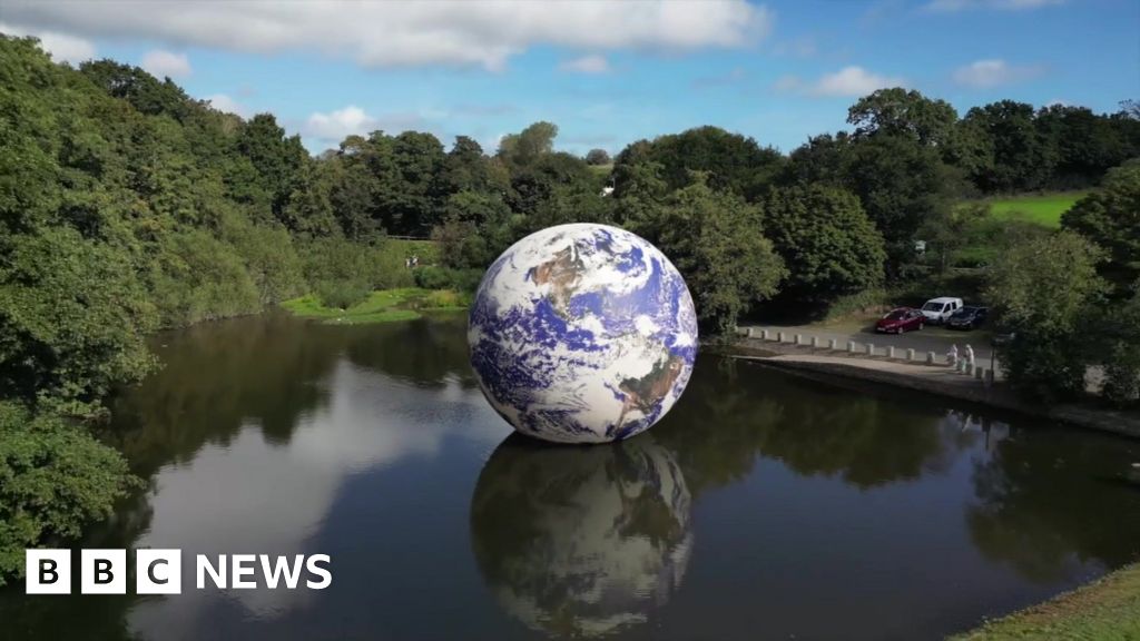 Giant Earth globe floating on Jersey reservoir