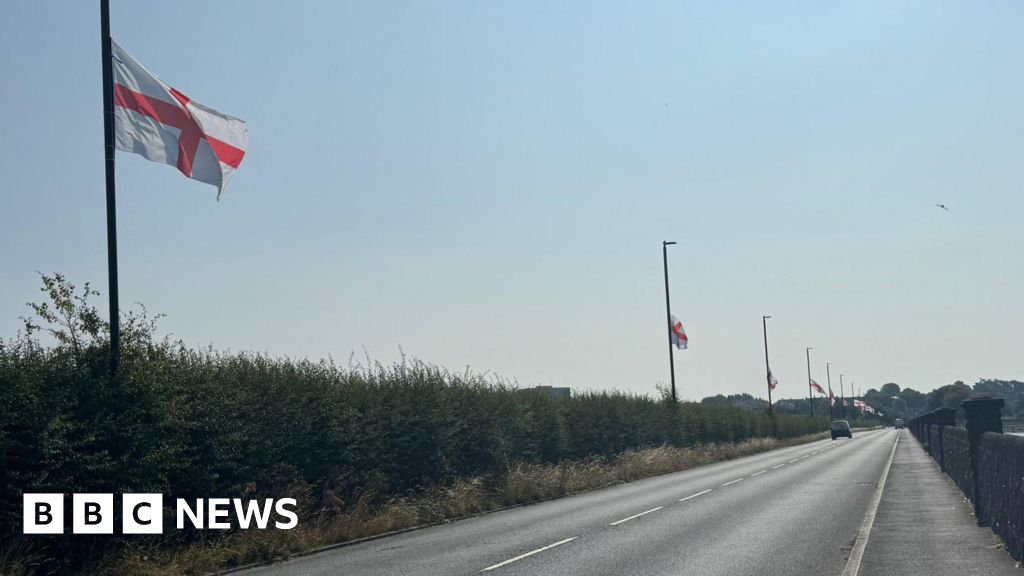 England flags hung by locals taken down