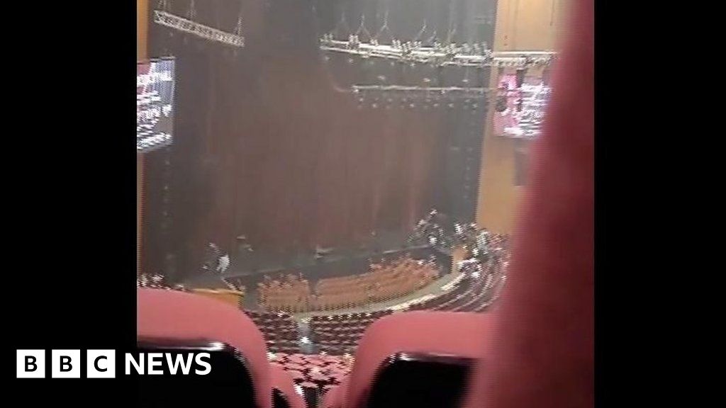 People take cover as gunmen enter Moscow concert hall