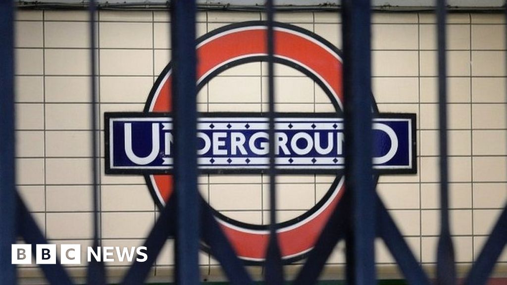 London Underground sign behind closed gates