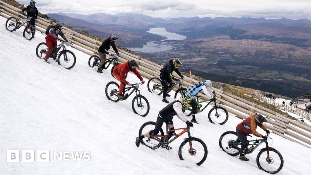 In pictures: Mountain bikers descend snowy peak