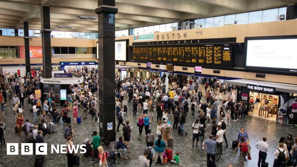 Interior view of the main concourse full of commuters and people travelling from Euston Railway Station in London in July 2018.