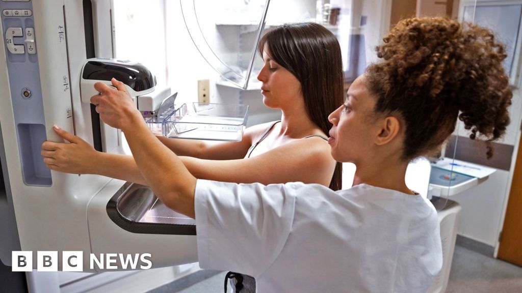 Photo: bbc.com A radiographer provides assistance to a patient undergoing a mammogram in a modern medical facility