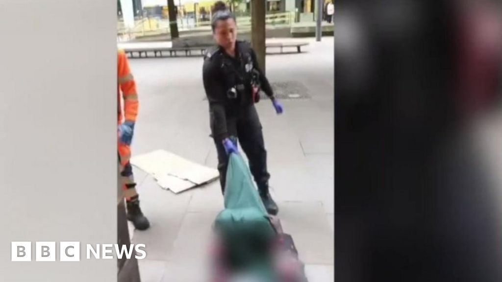 Police officer drags homeless man along ground