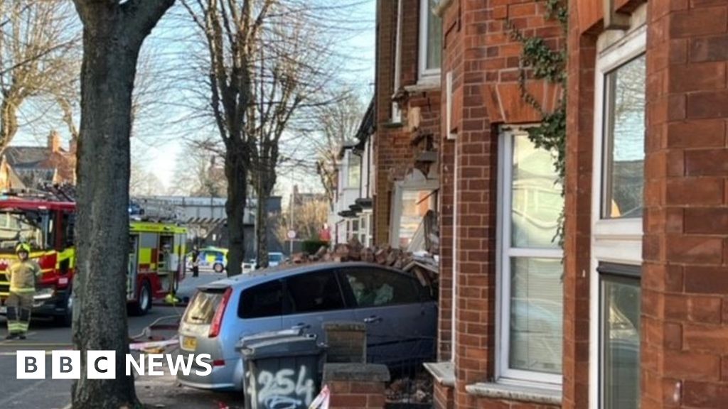 Search for driver after car crashes into Leicester property