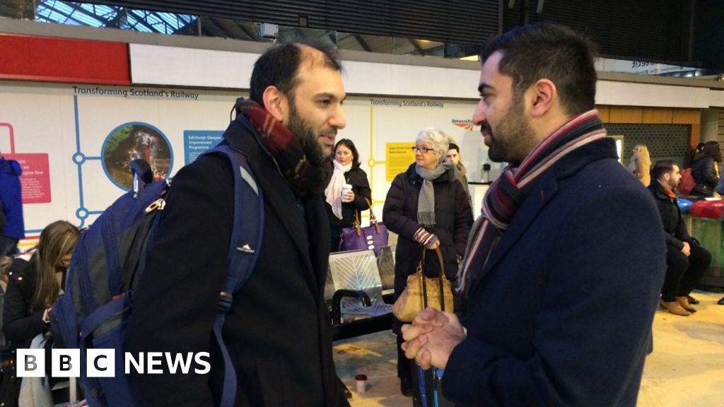 Humza Yousaf talking to passengers