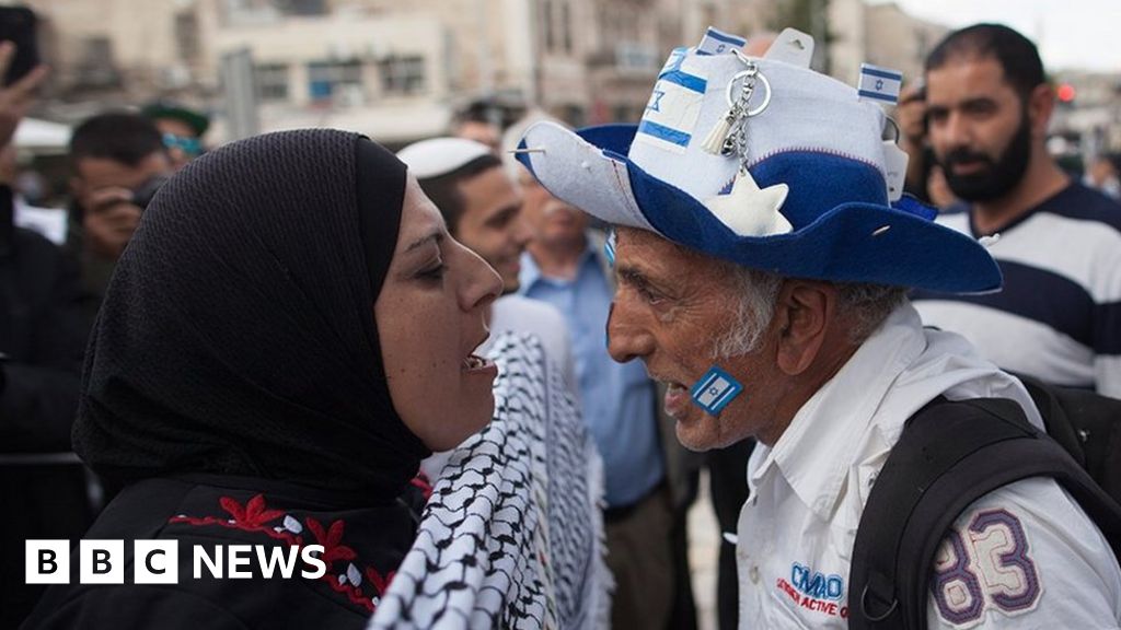 Close up of Palestinian men with keffiyeh walking in the street