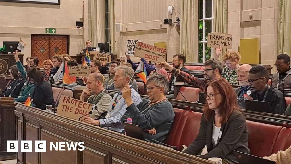 Trans rights signs held up during row in Bristol council meeting