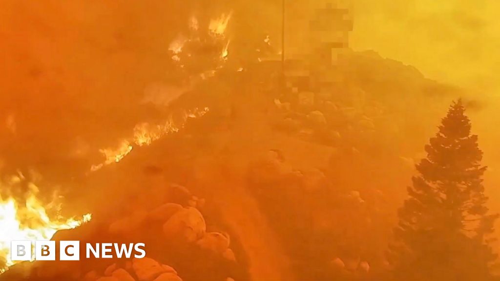 Orange skies and burned homes as wildfires spread near LA