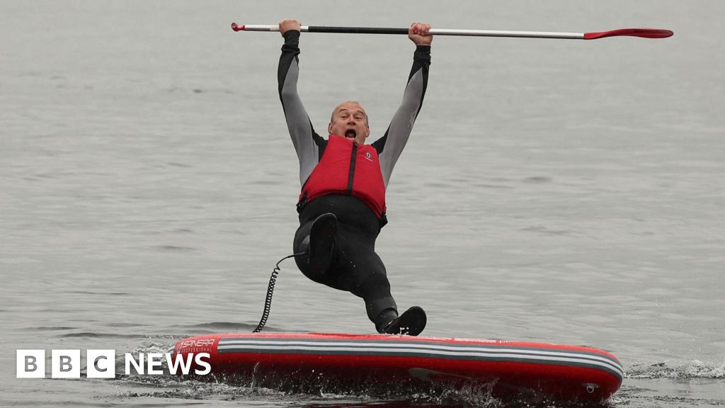 Going, going, gone: Ed Davey takes a dip in Windermere