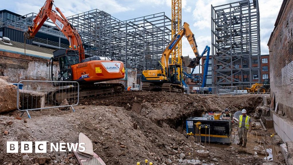 Two diggers work on demolition of old industrial and factory buildings to make way for housing in Birmingham