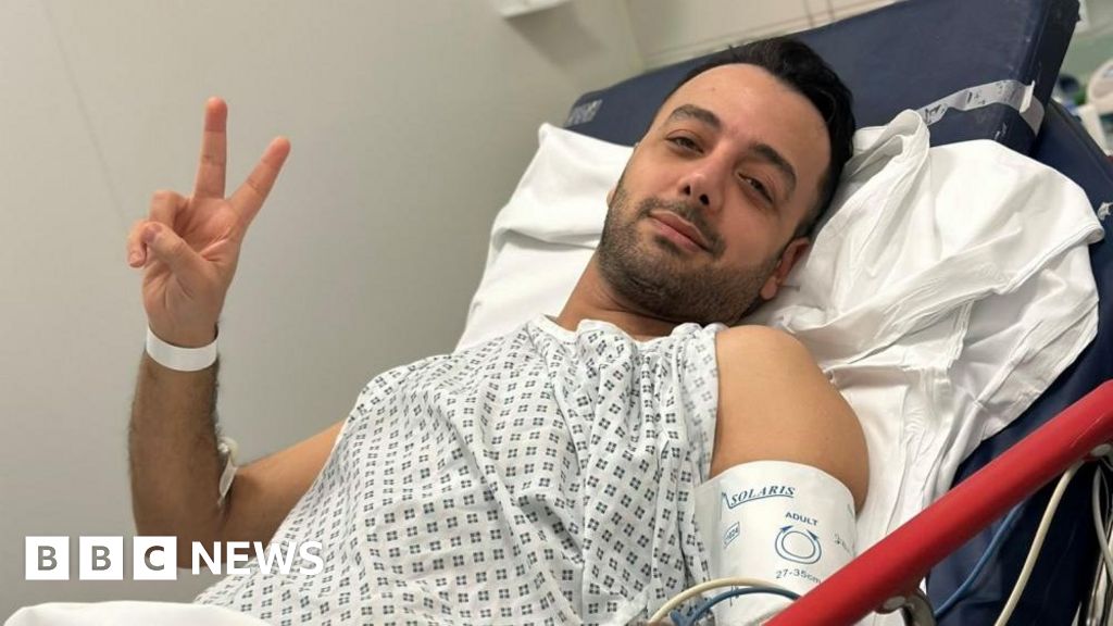 Stabbed Iranian TV host posts picture from hospital bed