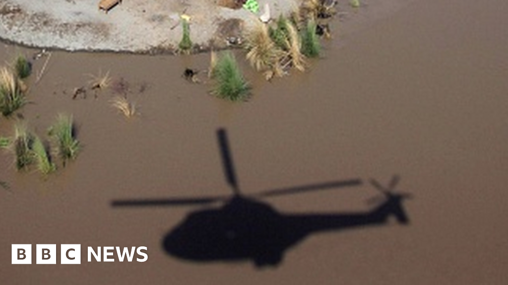 Helicopter lifts boy stranded in Pakistan flood