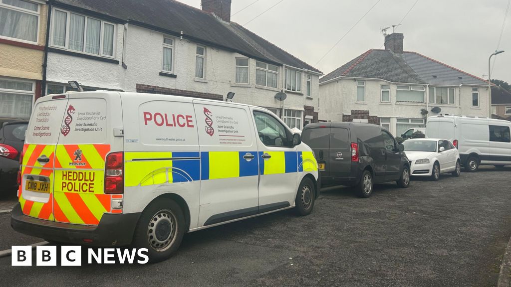 Woman's body found in freezer and man arrested