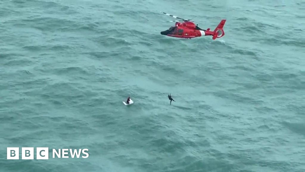 Moment US Coast Guard rescues man clinging to cooler