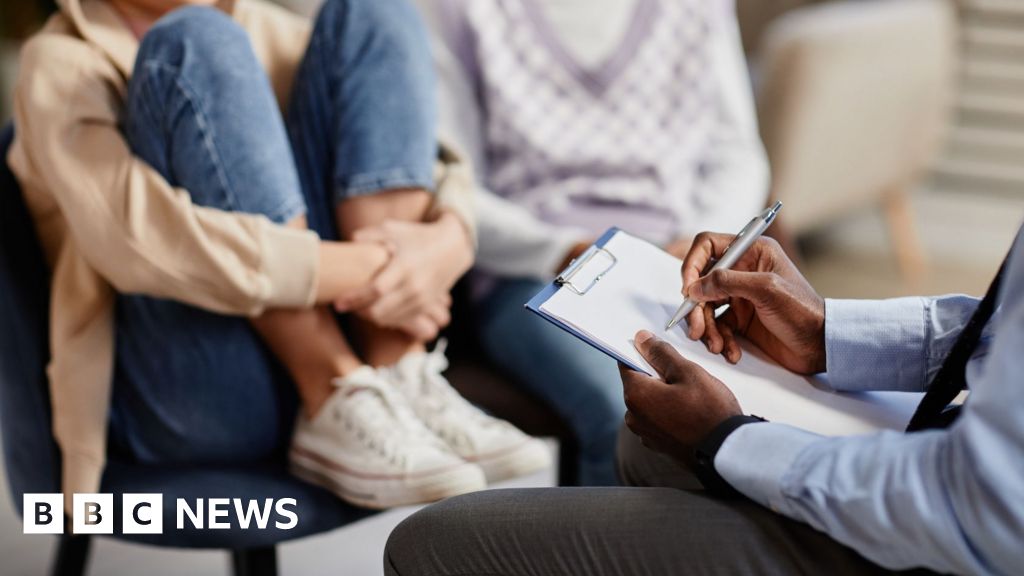 Anonymous young person sits on chair facing a doctor