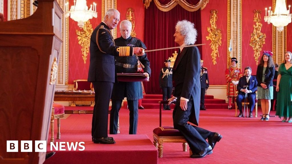Brian May knighted by King at Buckingham Palace