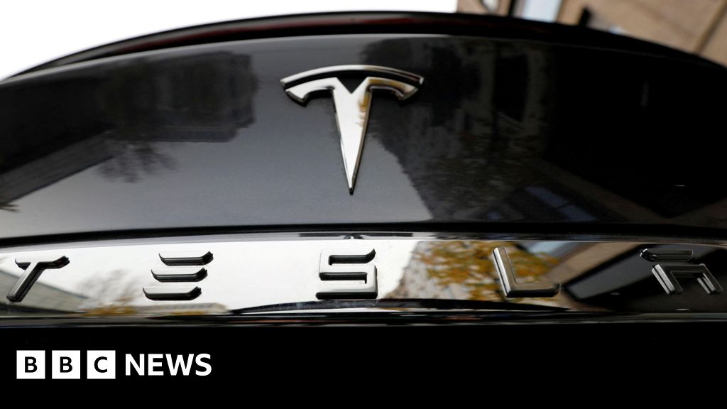 Tesla profits halved as demand falls
