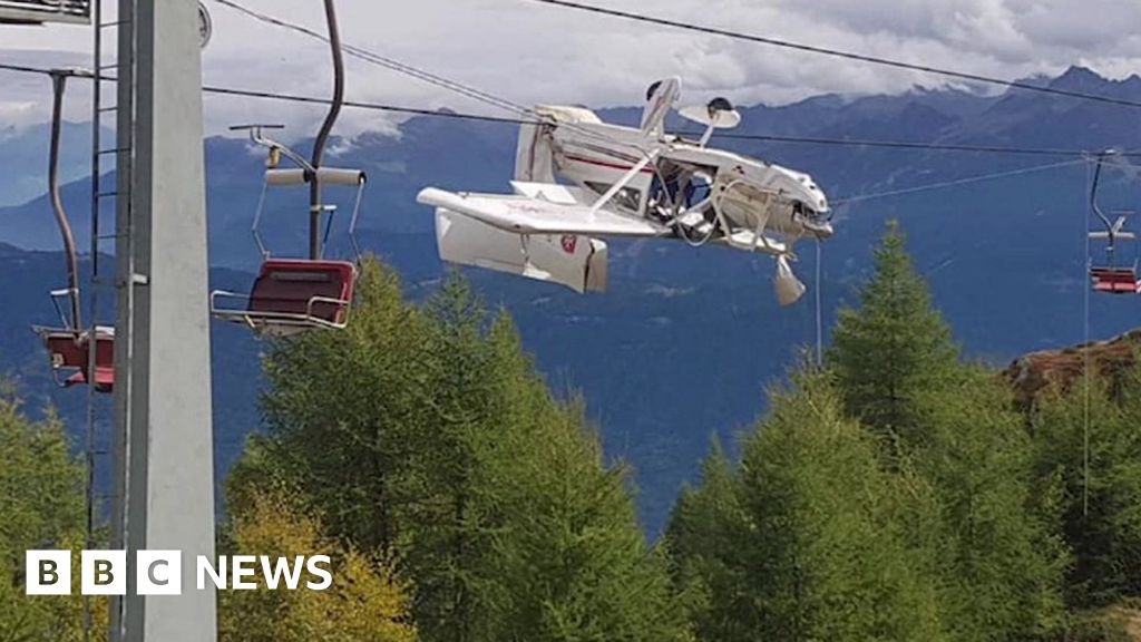 Plane left entangled in ski lift cables in Italian Alps after crash