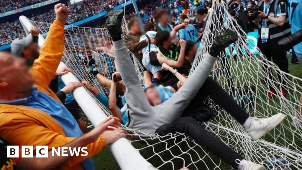 Two fans charged over Manchester City pitch invasion