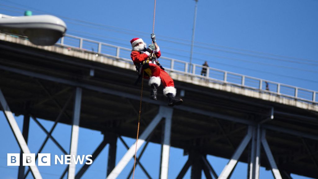 Abseiling Santa descends from Guatemala bridge to deliver toys