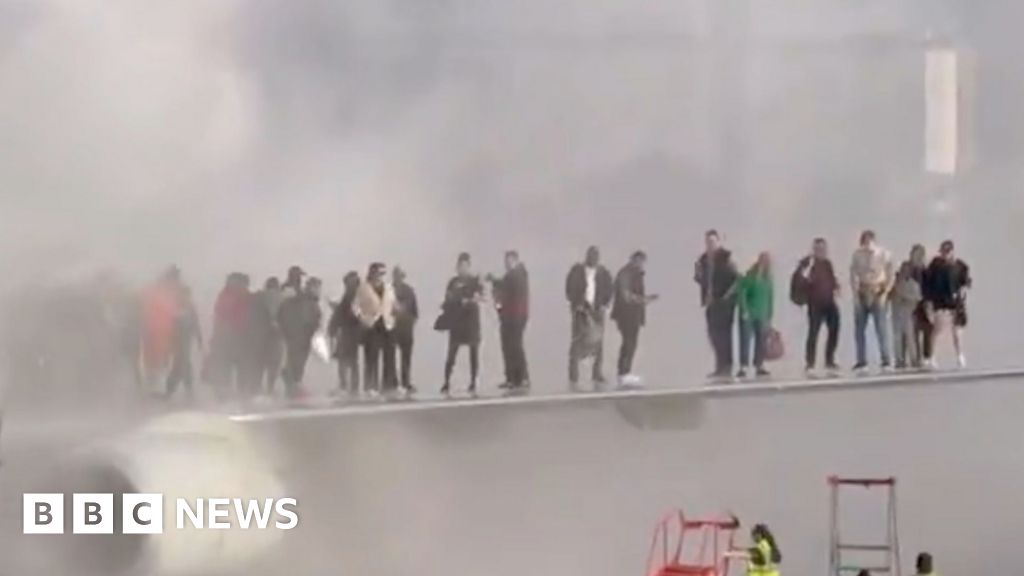 Watch: Passengers seen on wing of plane after jet catches fire