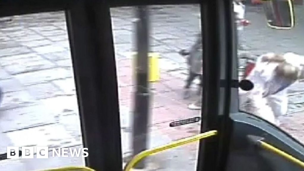 Moment woman pushed towards London bus - BBC News