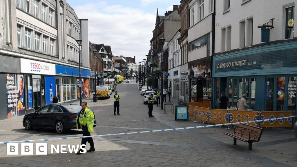 Two men arrested after customer stabbed to death in city centre bank