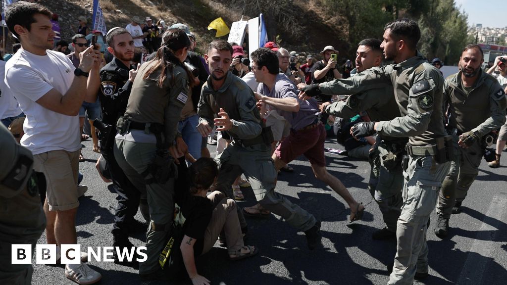 Israeli protesters are dragged away while blocking a major highway amid nationwide strike in Jerusalem on 17 August 2025.